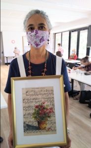 Yasmin with her gorgeous painting on an old music sheet